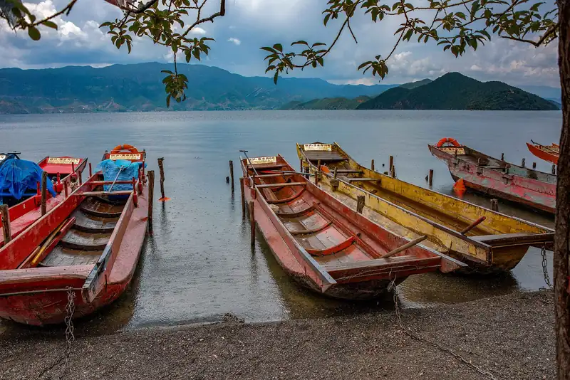 Wooden boats on the shore of Lugu Lake