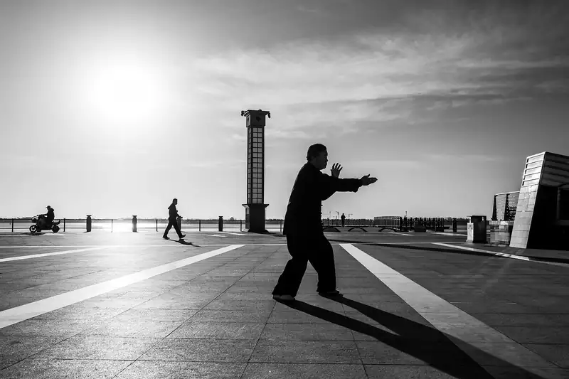 A man practicing tai chi at dawn